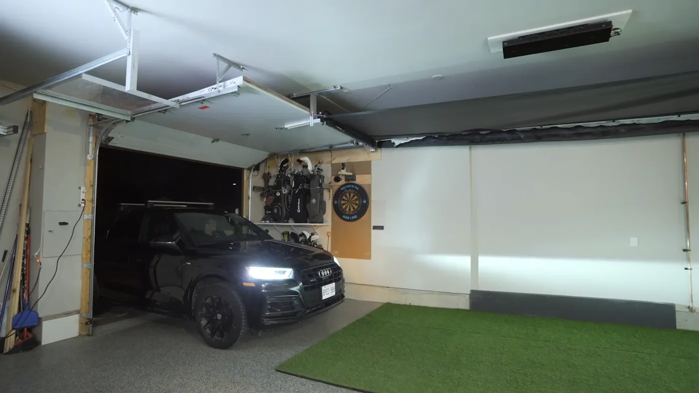 Retractable golf simulator enclosure in a garage